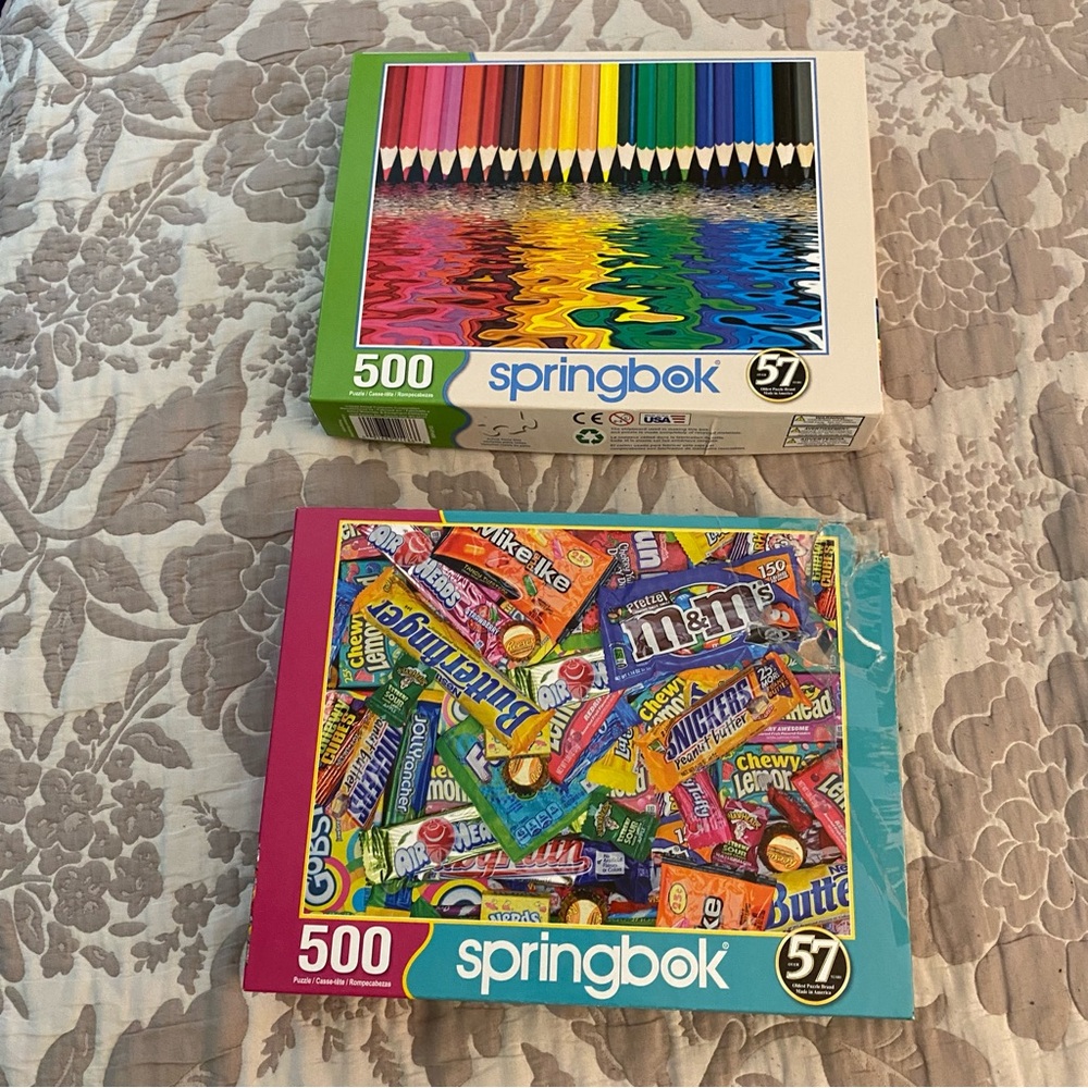 2 Springbok 500 piece puzzles featuring candy M&Ms and colorful pencils